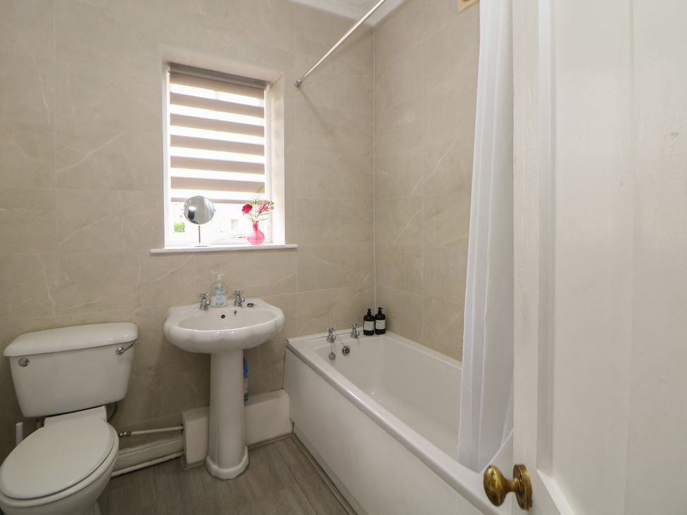 A bathroom with a bathtub and sink at Cherry Tree Cottage in Bakewell