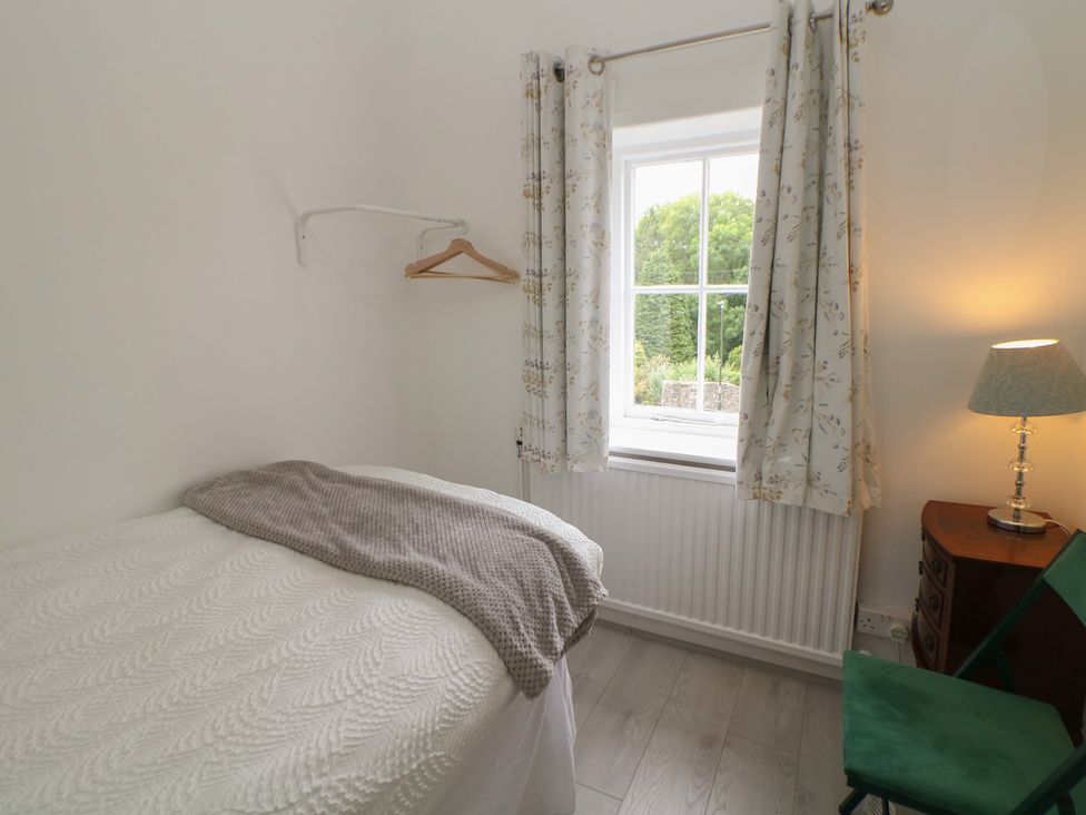 A bedroom with a bed and window at Cherry Tree Cottage in Bakewell