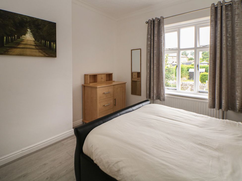 A bedroom with a bed and a drawer unit at Cherry Tree Cottage in Bakewell