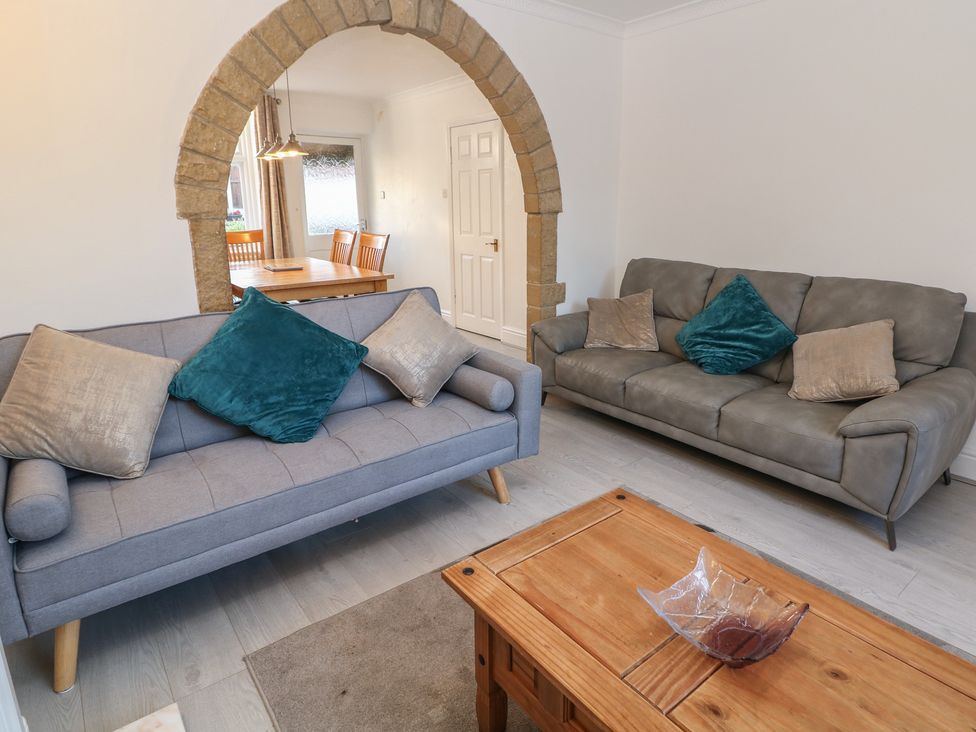 A living room with a sofa and a table at Cherry Tree Cottage, Bakewell