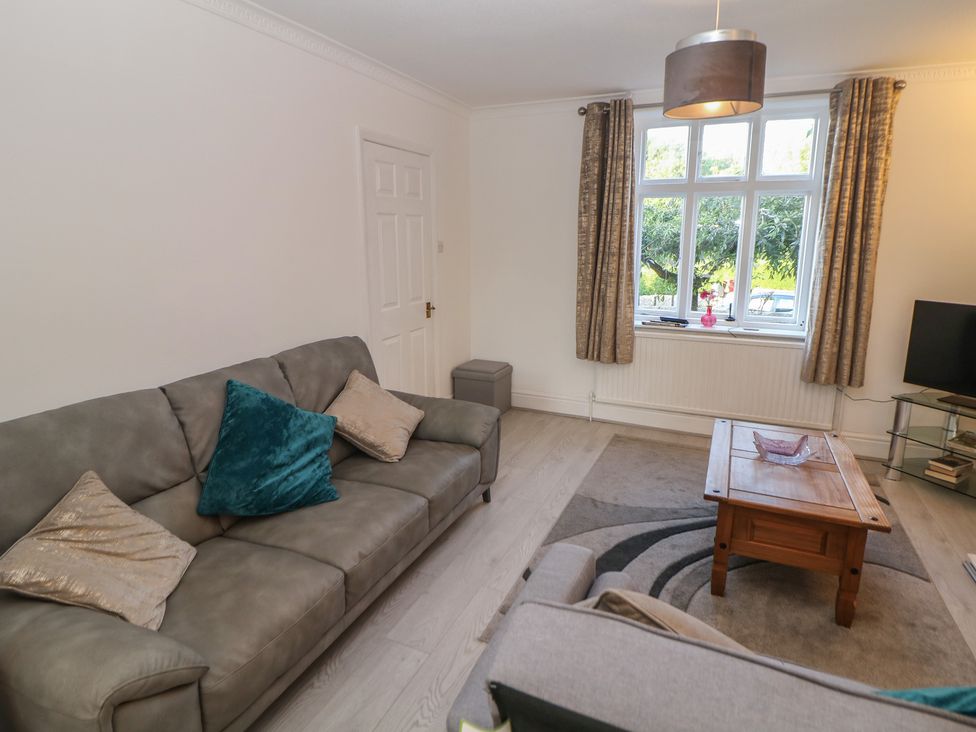 A living room with a sofa and a coffee table at Cherry Tree Cottage in Bakewell