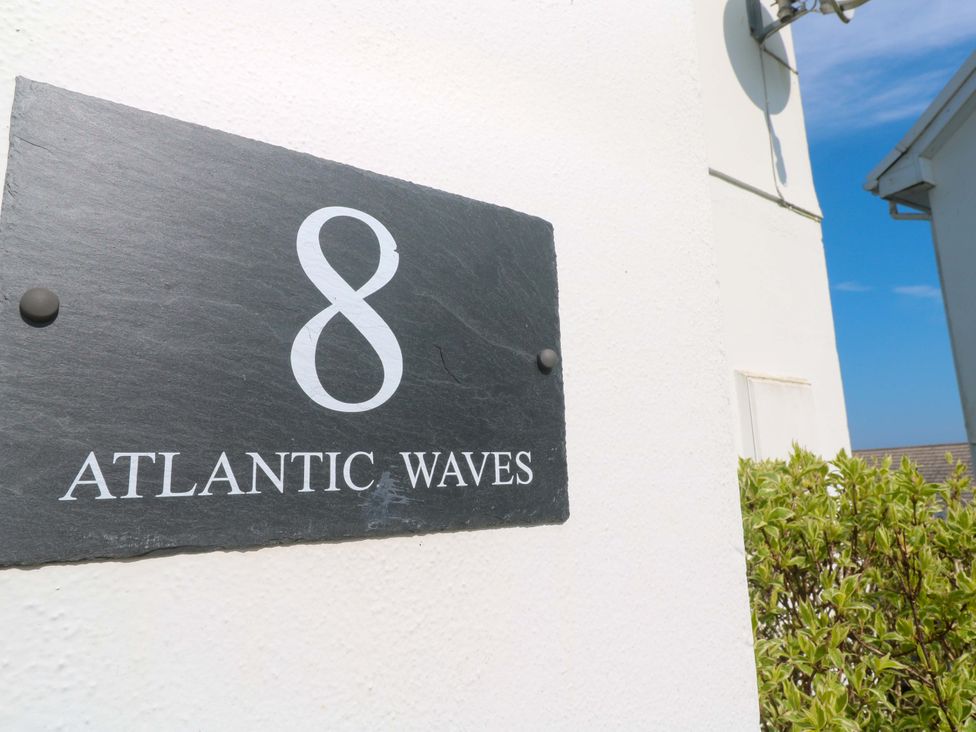 A nameplate displaying number 8 and text Atlantic Waves at Atlantic Waves in Carbis Bay
