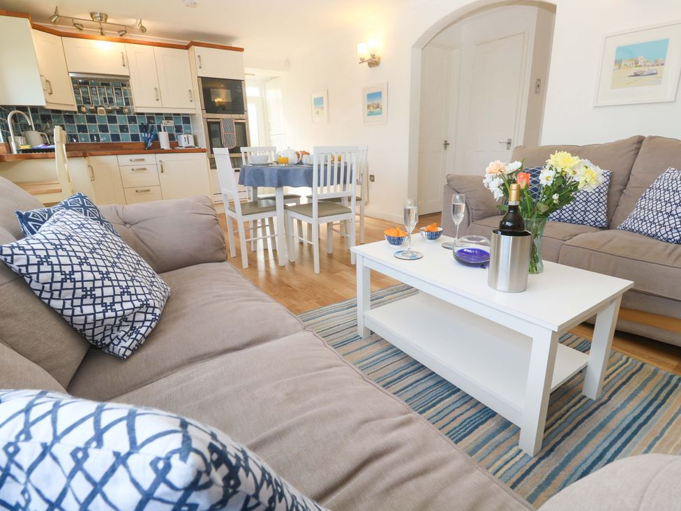 A living room with a dining area and kitchen at Atlantic Waves in Carbis Bay