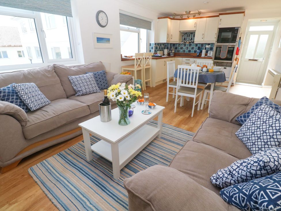A living room with sofas and a dining table at Atlantic Waves in Carbis Bay