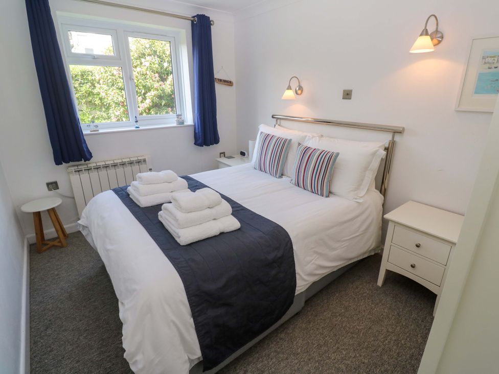A bedroom with a bed and window at Atlantic Waves in Carbis Bay