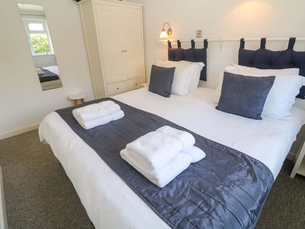 A bedroom with a bed and towels on it at Atlantic Waves in Carbis Bay