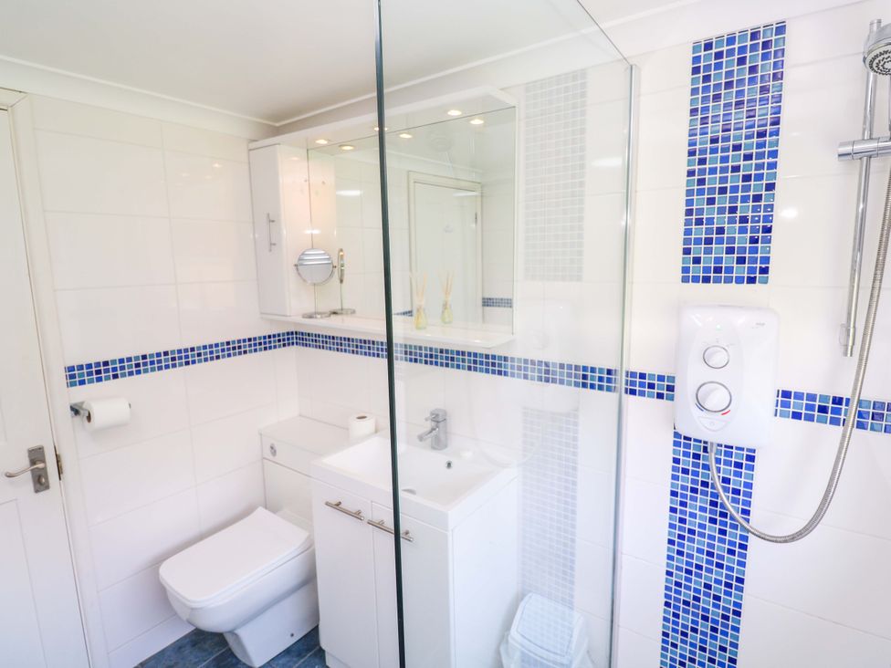 A bathroom featuring a shower, sink, and toilet at Atlantic Waves in Carbis Bay