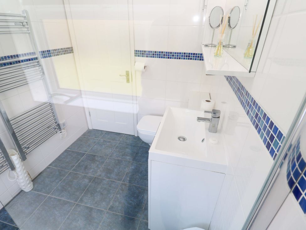 A bathroom with a sink, toilet, and towel rail at Atlantic Waves in Carbis Bay