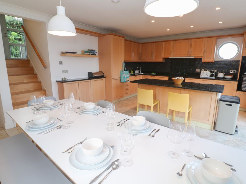 A kitchen with dining table and chairs at Bayside in Carbis Bay