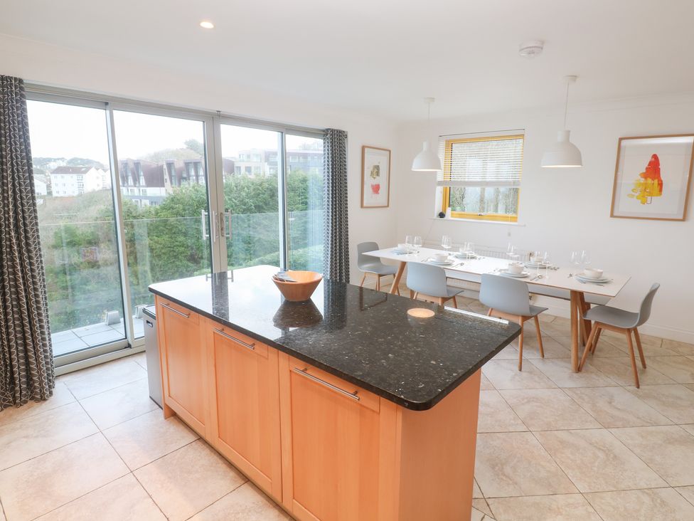A kitchen with an island and dining area at Bayside in Carbis Bay