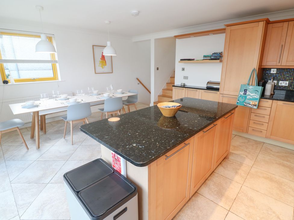 A kitchen with a table and chairs at Bayside in Carbis Bay
