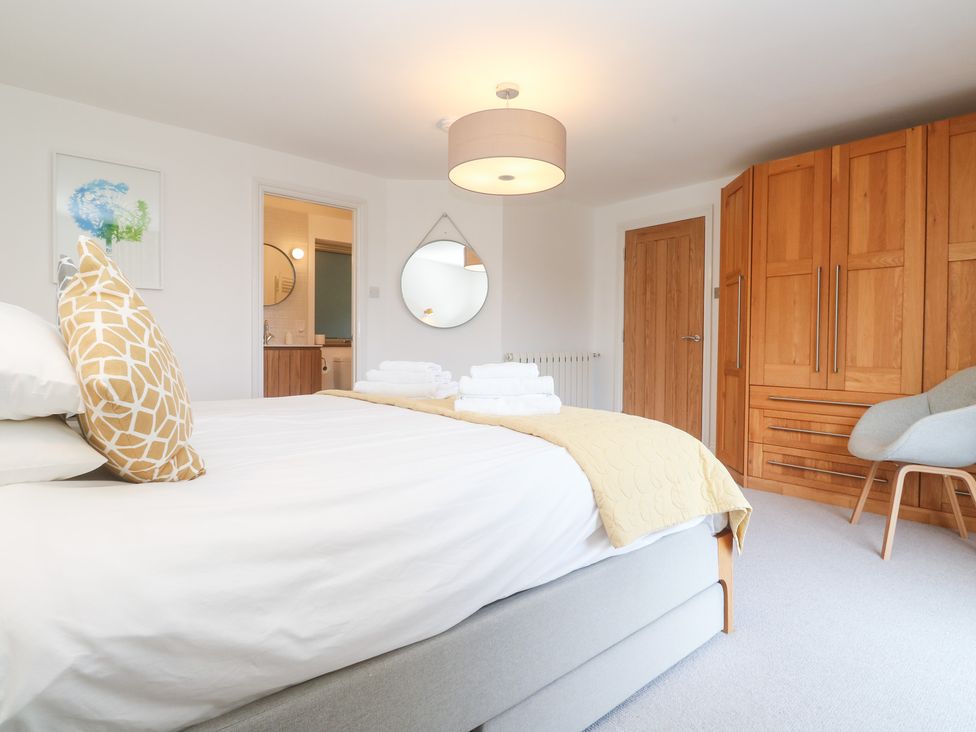 A bedroom with a bed and wardrobe at Bayside in Carbis Bay