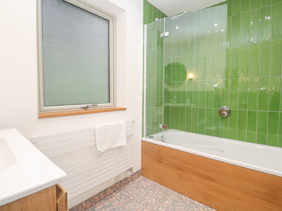 A bathroom with a bathtub and sink at Bayside in Carbis Bay