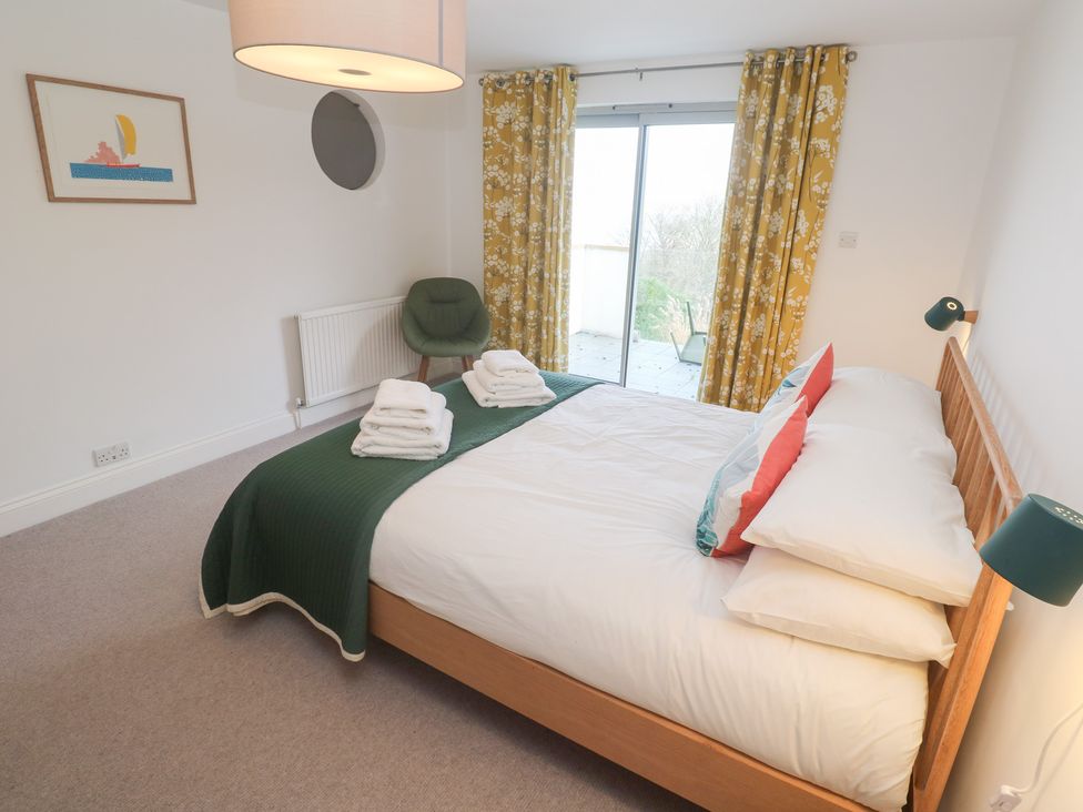 A bedroom with a bed and chair at Bayside in Carbis Bay