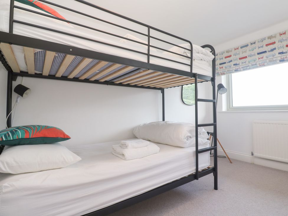 A bedroom with a bunk bed and a window at Bayside in Carbis Bay