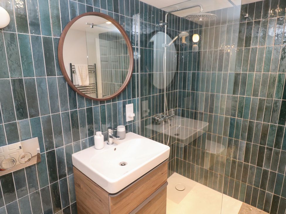A bathroom featuring a sink, shower, and mirror at Bayside, Carbis Bay