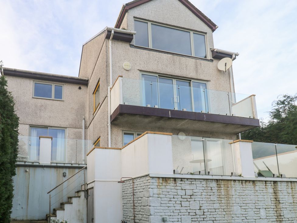 A house with a balcony and windows at Bayside, Carbis Bay
