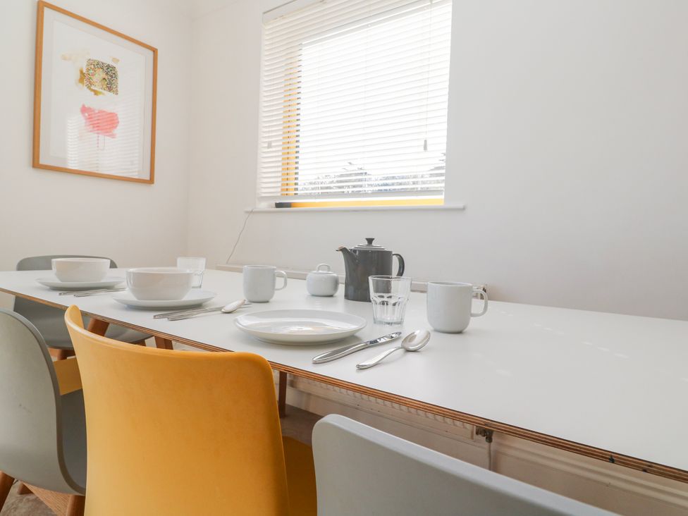 A dining room with a table set for meals at Bayside in Carbis Bay