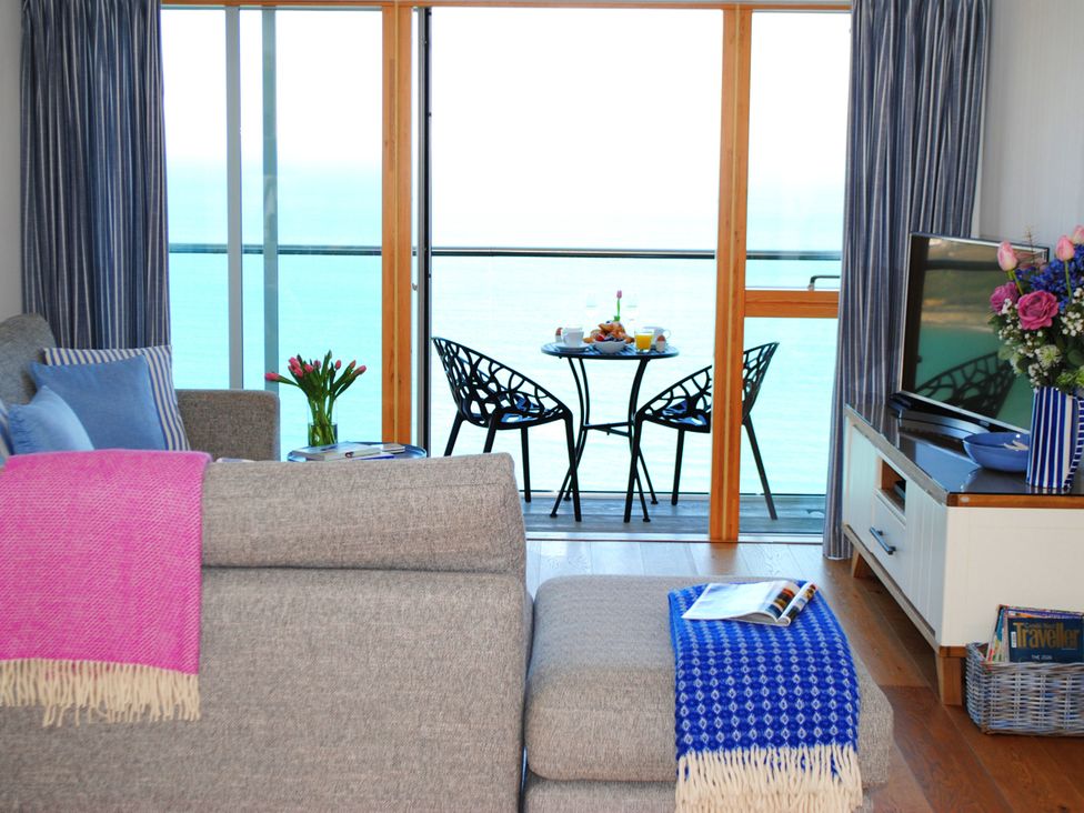 A living room with a view of the sea at Sea Mist in Carbis Bay