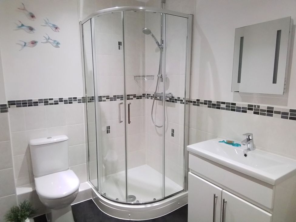 A bathroom with a shower and sink at Sea Mist in Carbis Bay