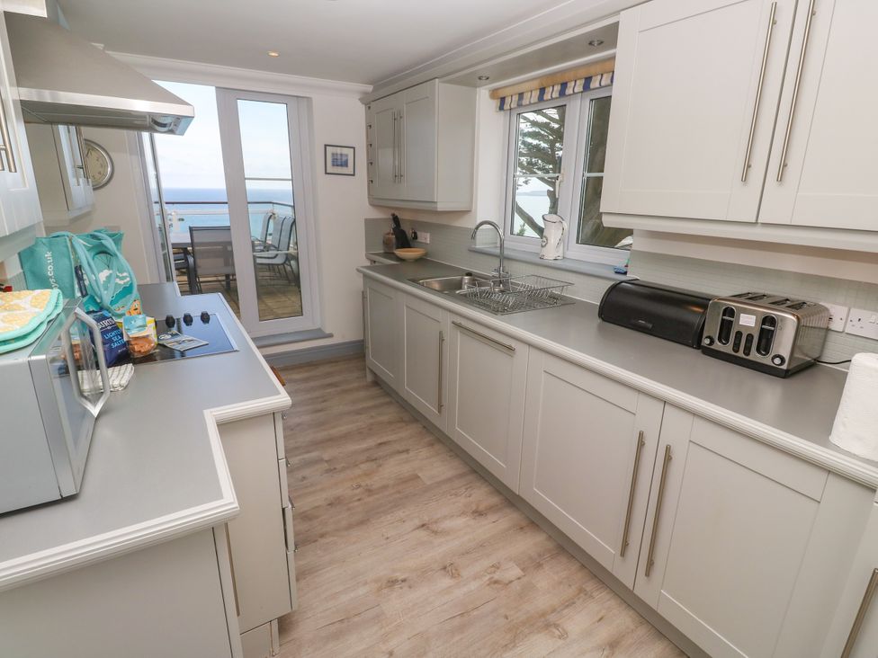A kitchen with a microwave and sink at Ocean Gem in Carbis Bay