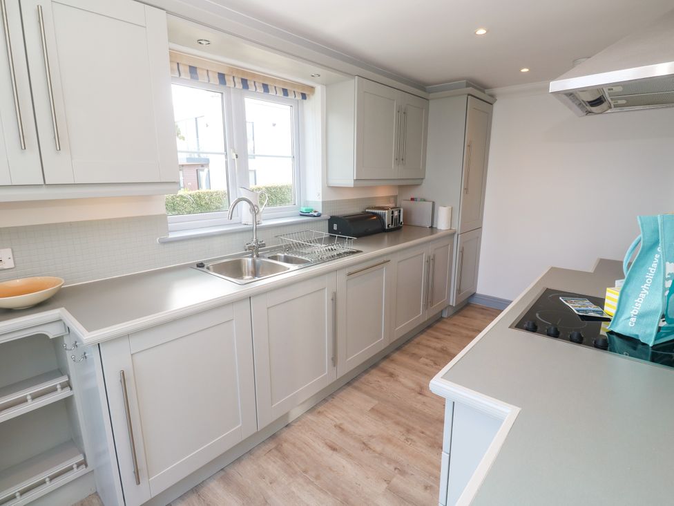 A kitchen with cabinets, sink, and countertop at Ocean Gem in Carbis Bay