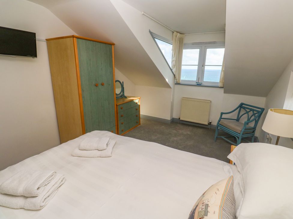 A bedroom with a bed and furniture at Ocean Gem in Carbis Bay