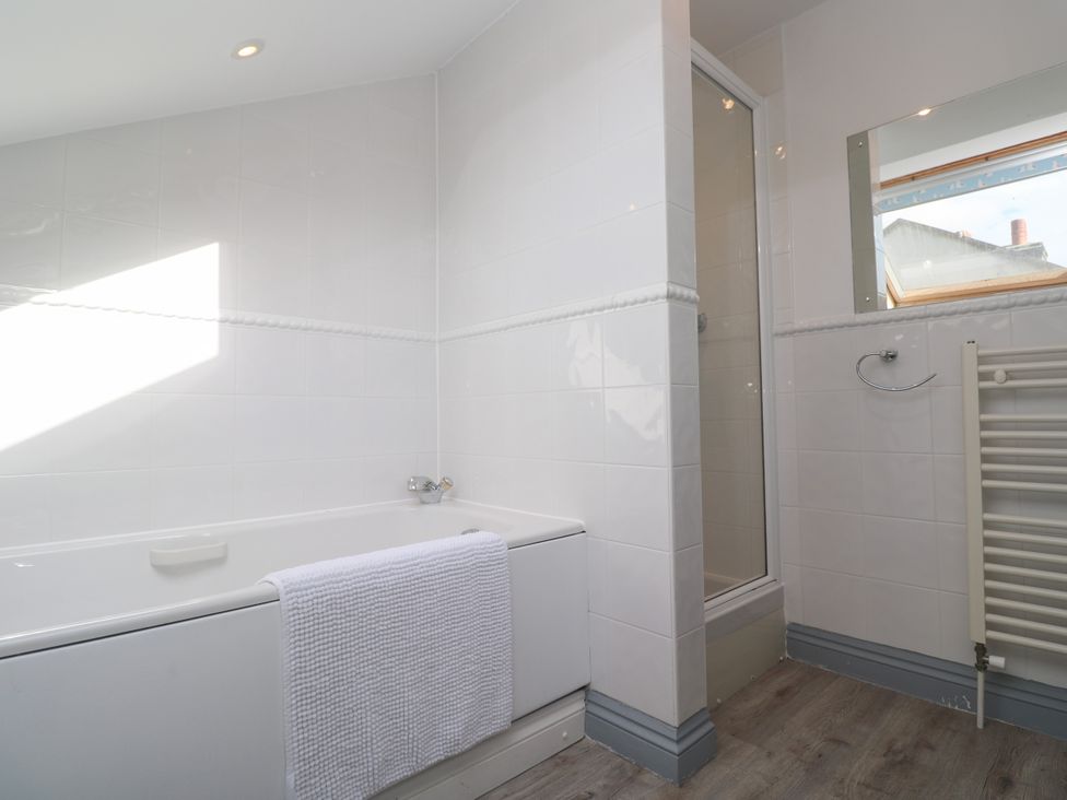 A bathroom with a bathtub and shower at Ocean Gem in Carbis Bay