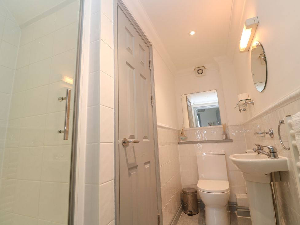 A bathroom with a shower, toilet, and sink at Ocean Gem in Carbis Bay