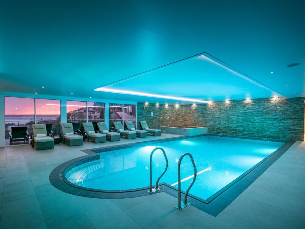 A pool area with reclining chairs and a swimming pool at 4shore St Ives