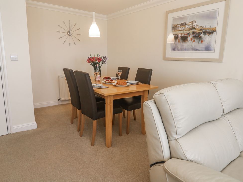 A dining room with a table and chairs at Golva in Carbis Bay