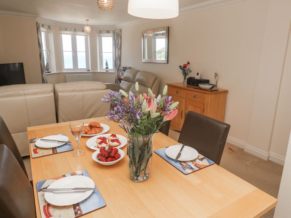 A dining room with a table set for a meal at Golva in Carbis Bay