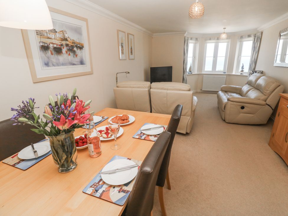 A dining room with a table set for a meal at Golva in Carbis Bay