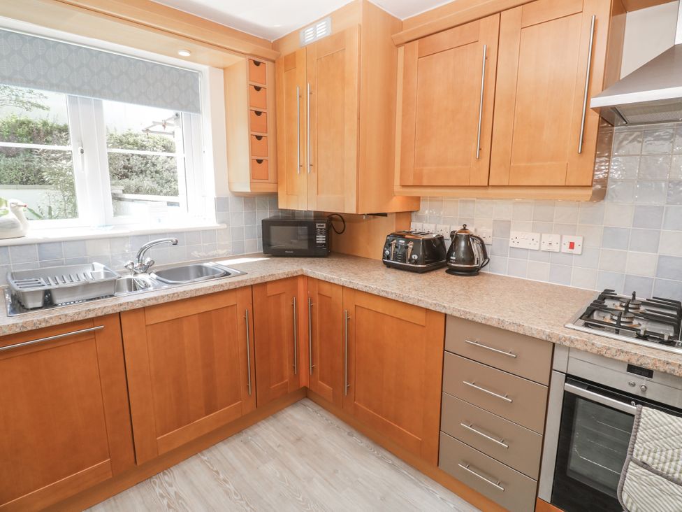 A kitchen with cabinets and appliances at Golva in Carbis Bay