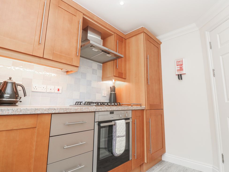 A kitchen with cabinets and appliances at Golva in Carbis Bay