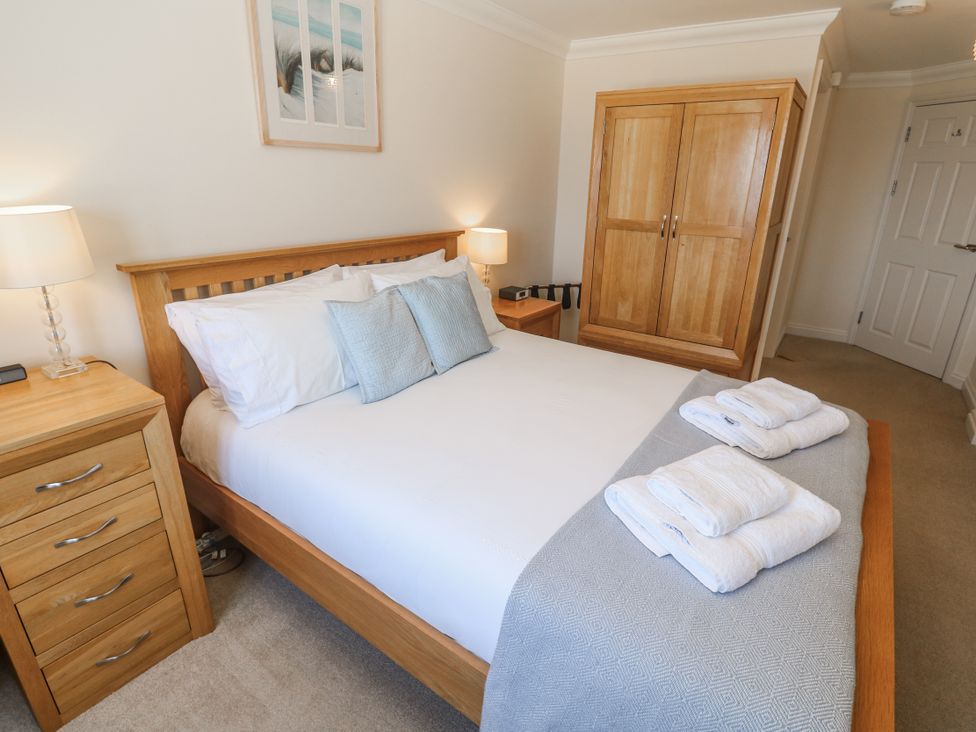 A bedroom with a bed and nightstand at Golva in Carbis Bay