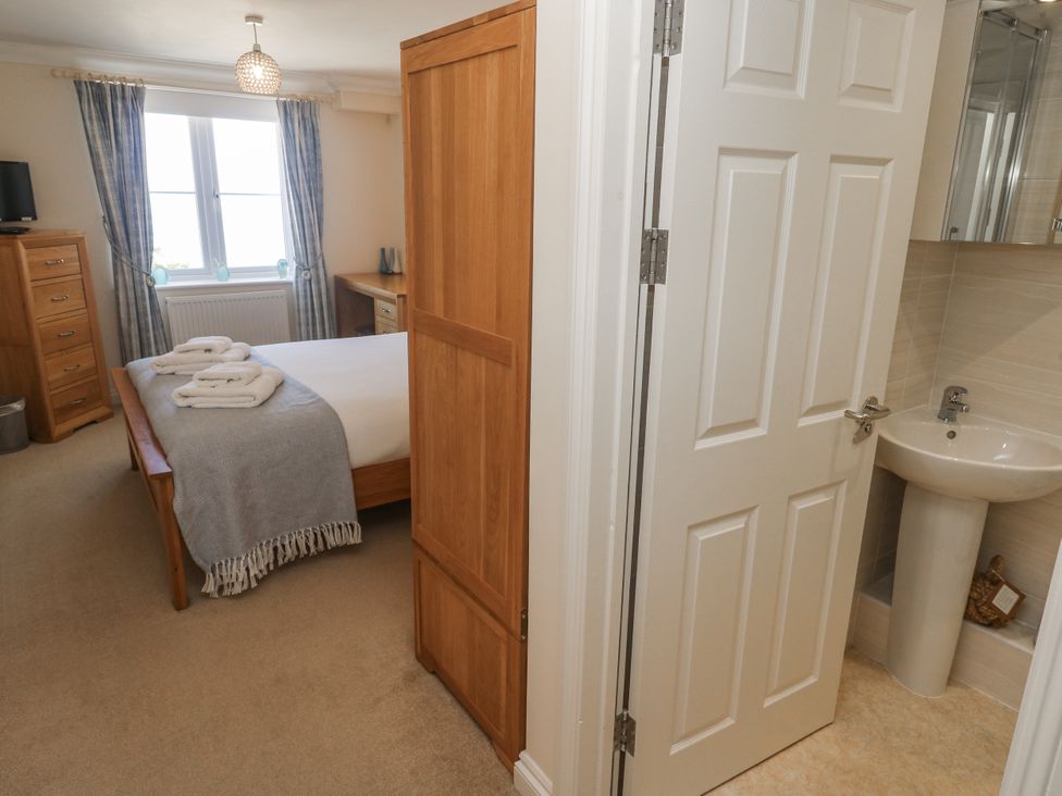 A bedroom with a bed and wardrobe at Golva Carbis Bay