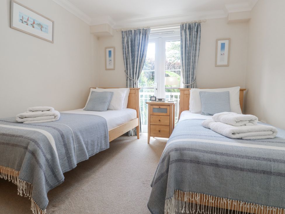 A bedroom with two beds and a window at Golva in Carbis Bay