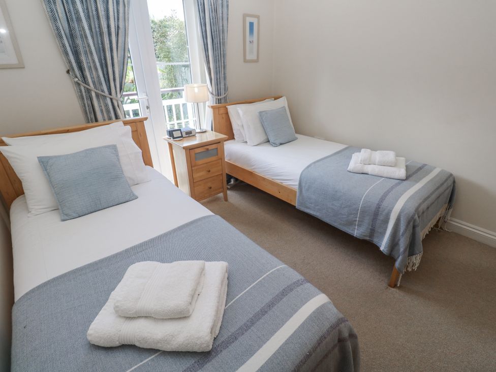A bedroom with two single beds and a nightstand at Golva in Carbis Bay