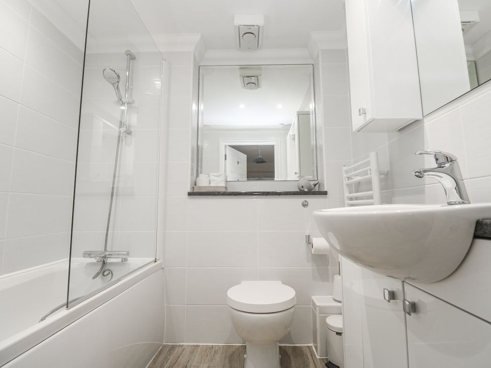 A bathroom with a shower, bathtub, sink and toilet at Golva in Carbis Bay