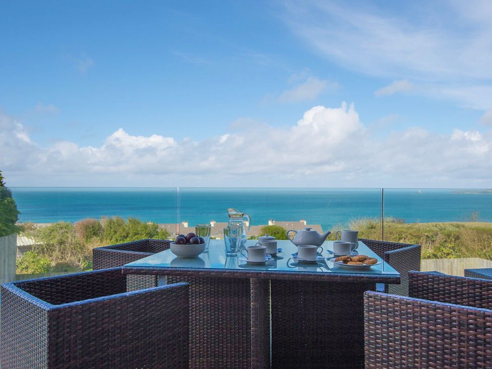 An outdoor dining area with a table set for tea at Halcyon Cove in Carbis Bay