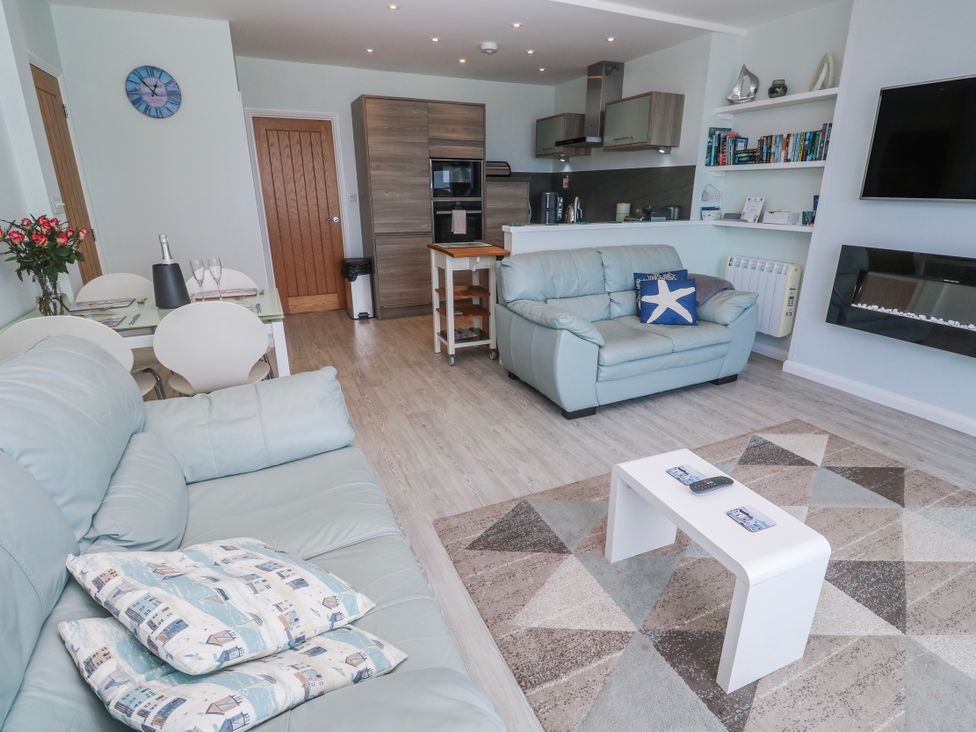 A living room with a kitchen area at Island View in Carbis Bay
