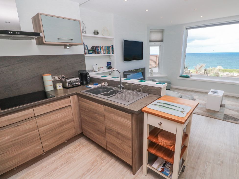 A kitchen with a view of the sea at Island View in Carbis Bay