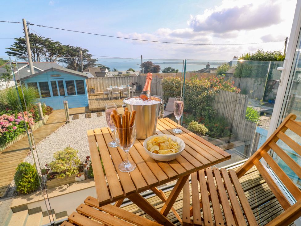 A table with champagne and snacks in a garden at Sea Breeze in Carbis Bay