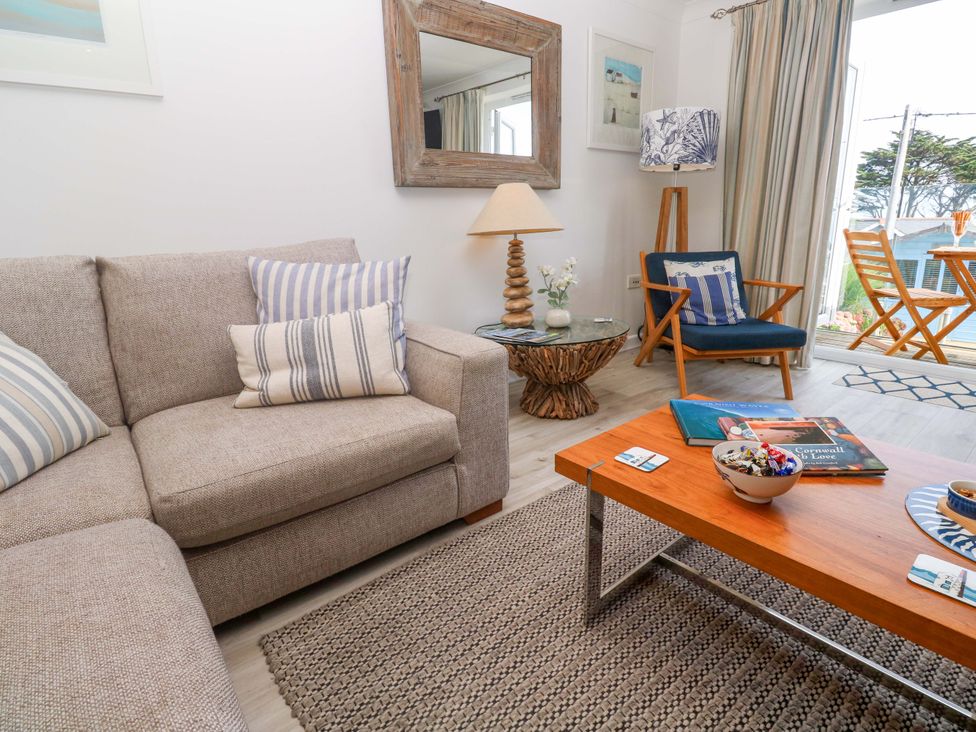A living room with a sofa and coffee table at Sea Breeze in Carbis Bay