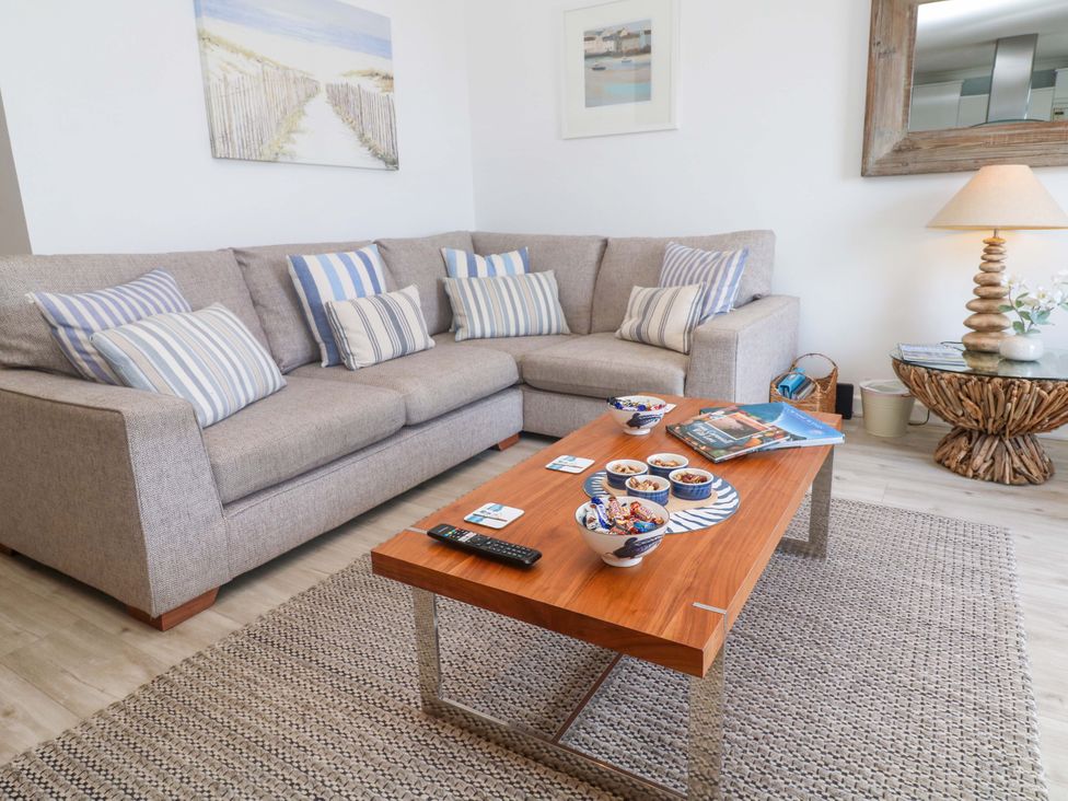 A living room with a sofa and coffee table at Sea Breeze in Carbis Bay