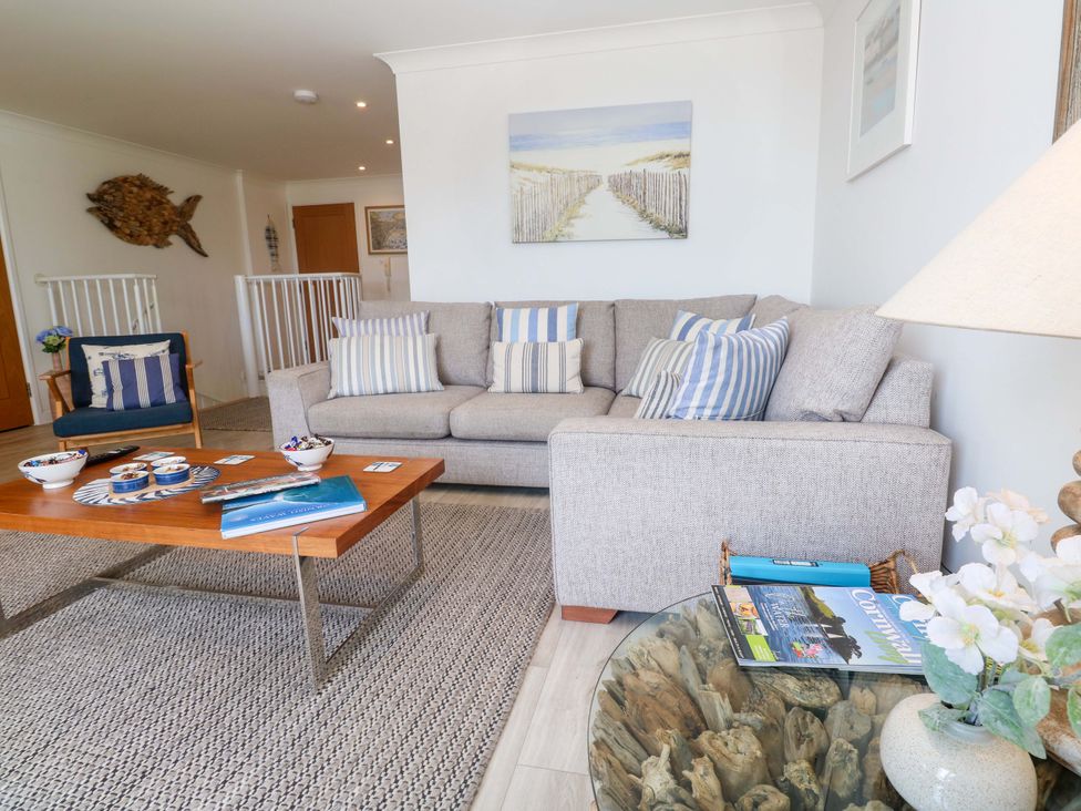 A living room with a sofa and coffee table at Sea Breeze in Carbis Bay