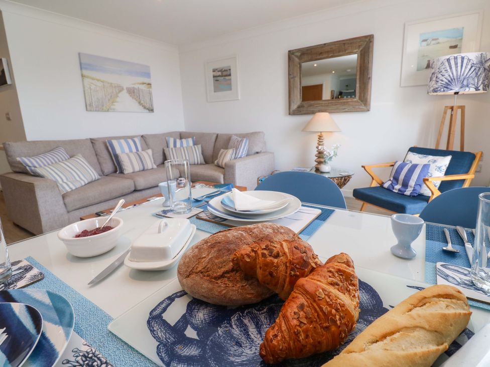 A dining room with a table set for breakfast at Sea Breeze in Carbis Bay