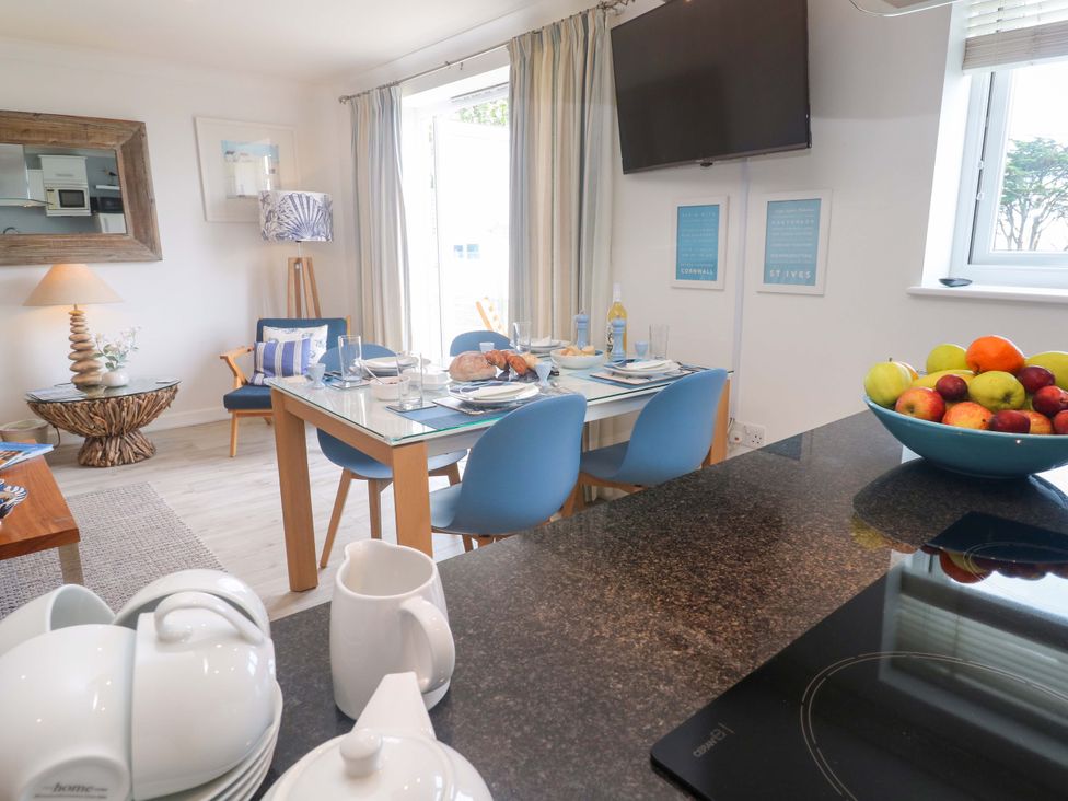 A dining room with a table set for a meal at Sea Breeze in Carbis Bay