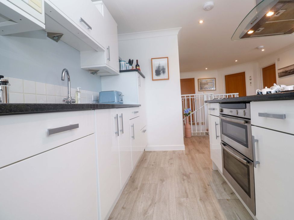 A kitchen with cabinets and appliances at Sea Breeze Carbis Bay